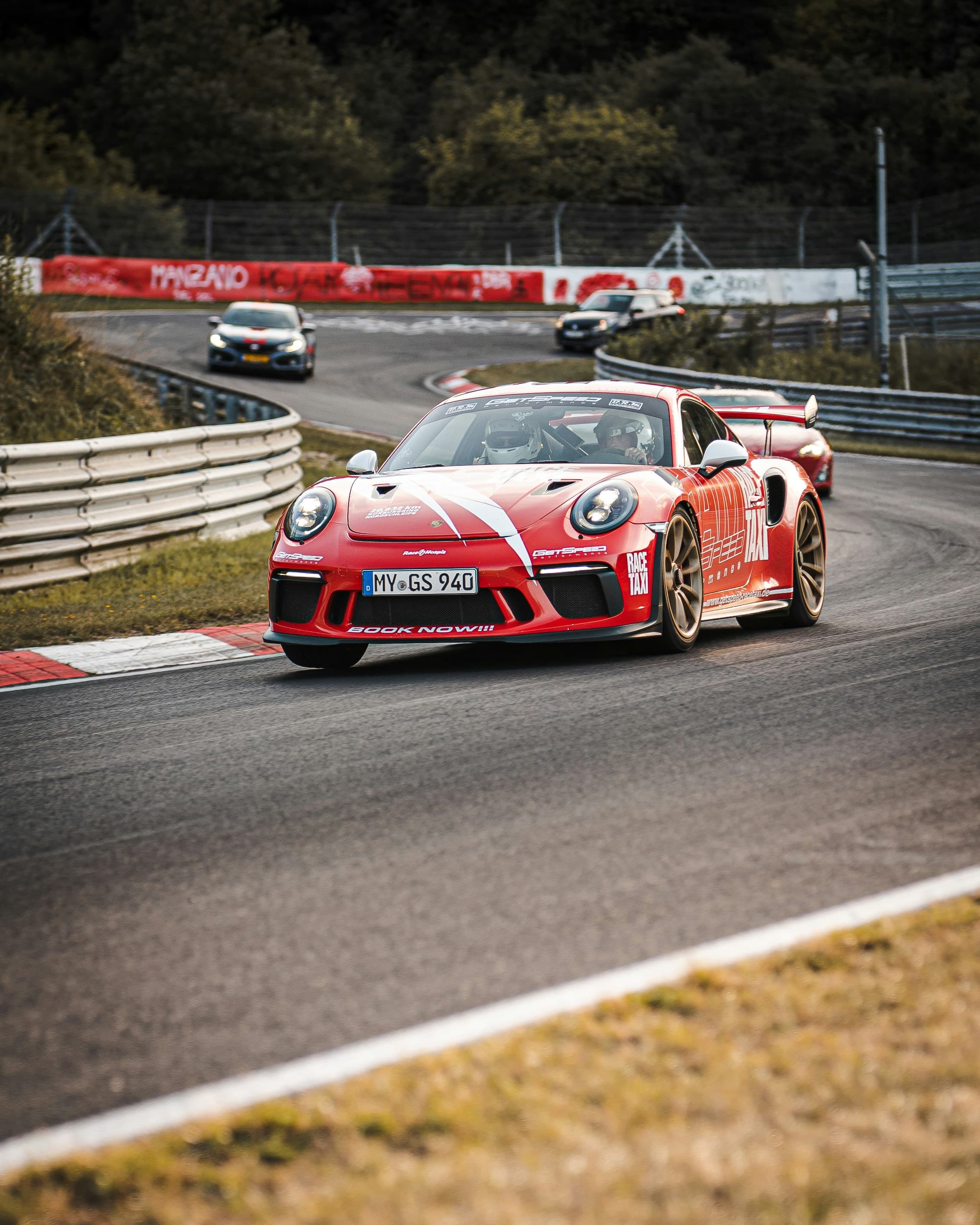 A red and white race car on track. Photo by Mika Baumeister on Unsplash