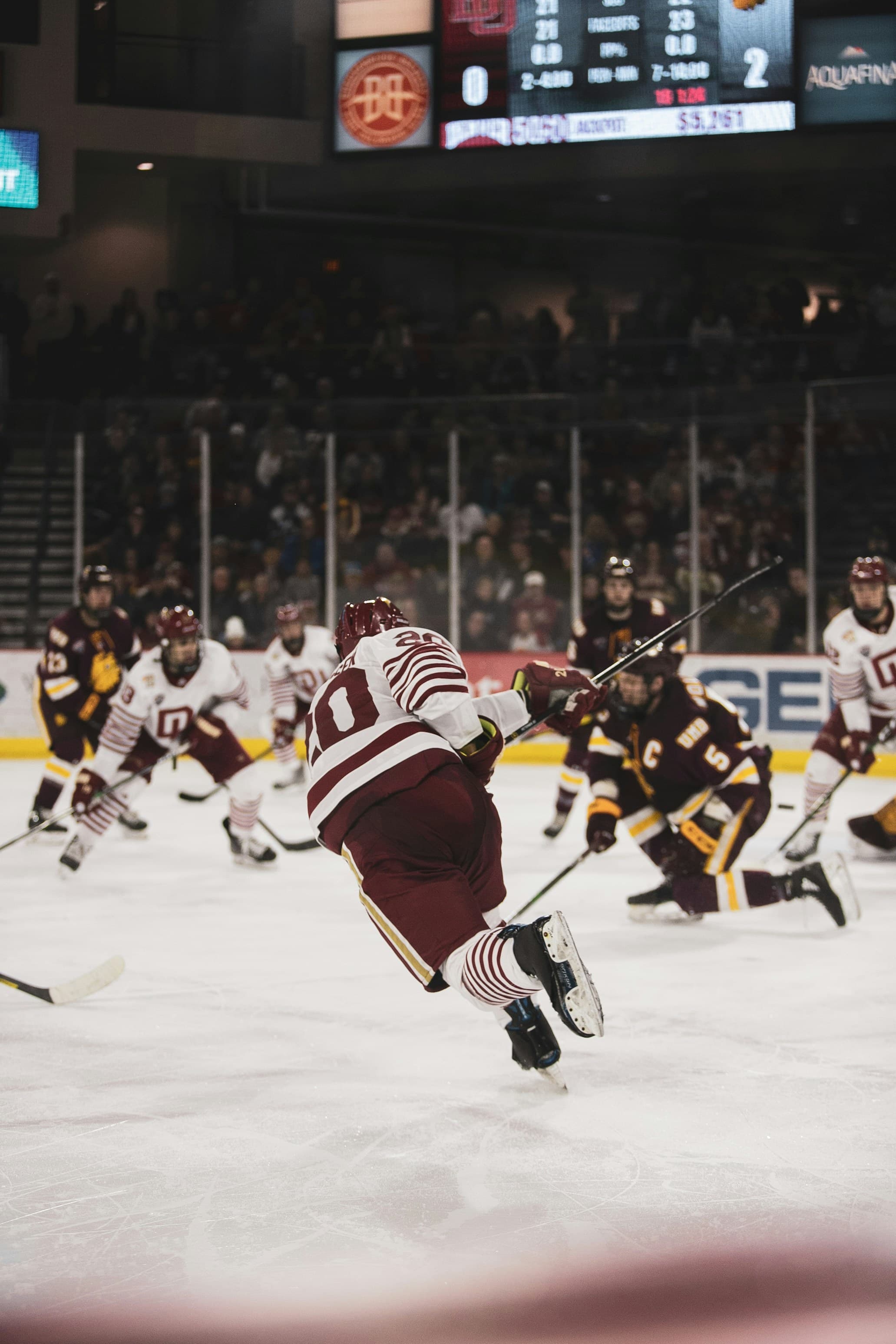 Ice hockey players skating in an arena. Photo by Logan Weaver on Unsplash