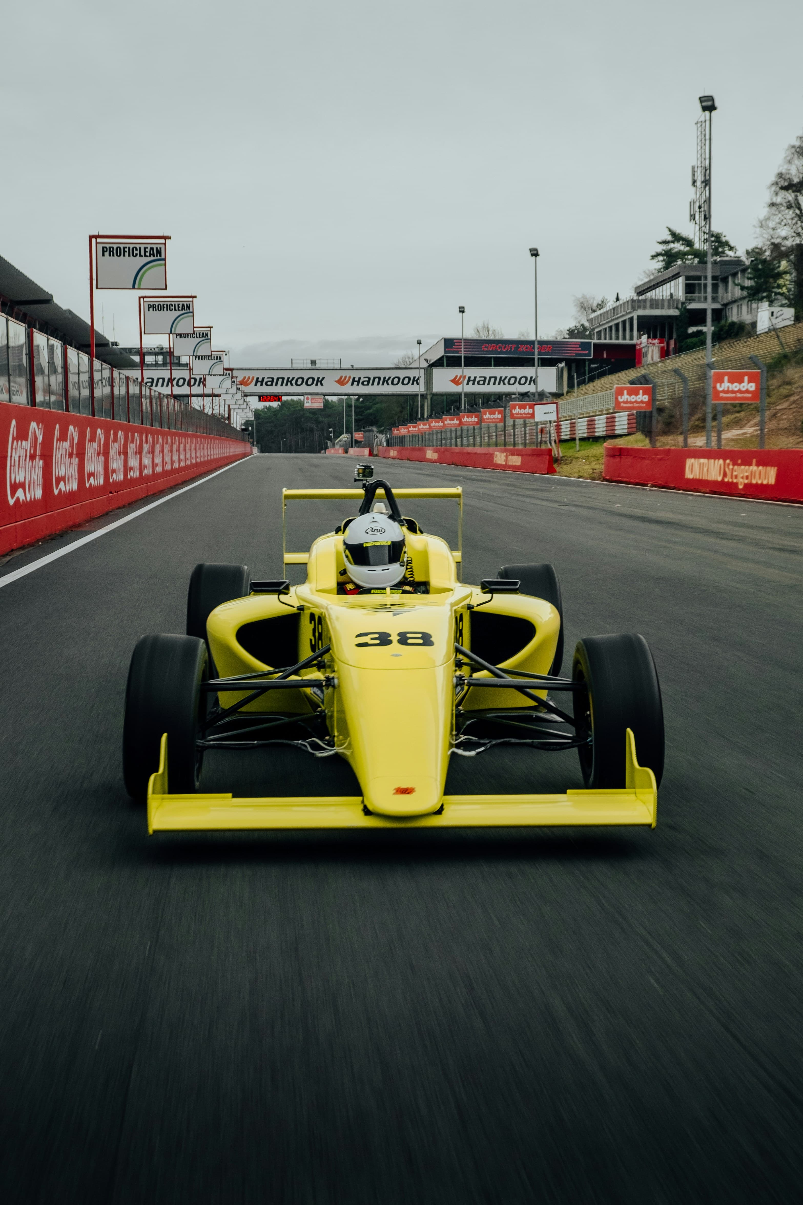 A yellow and black F1 car on track. Photo by Kenny Leys on Unsplash