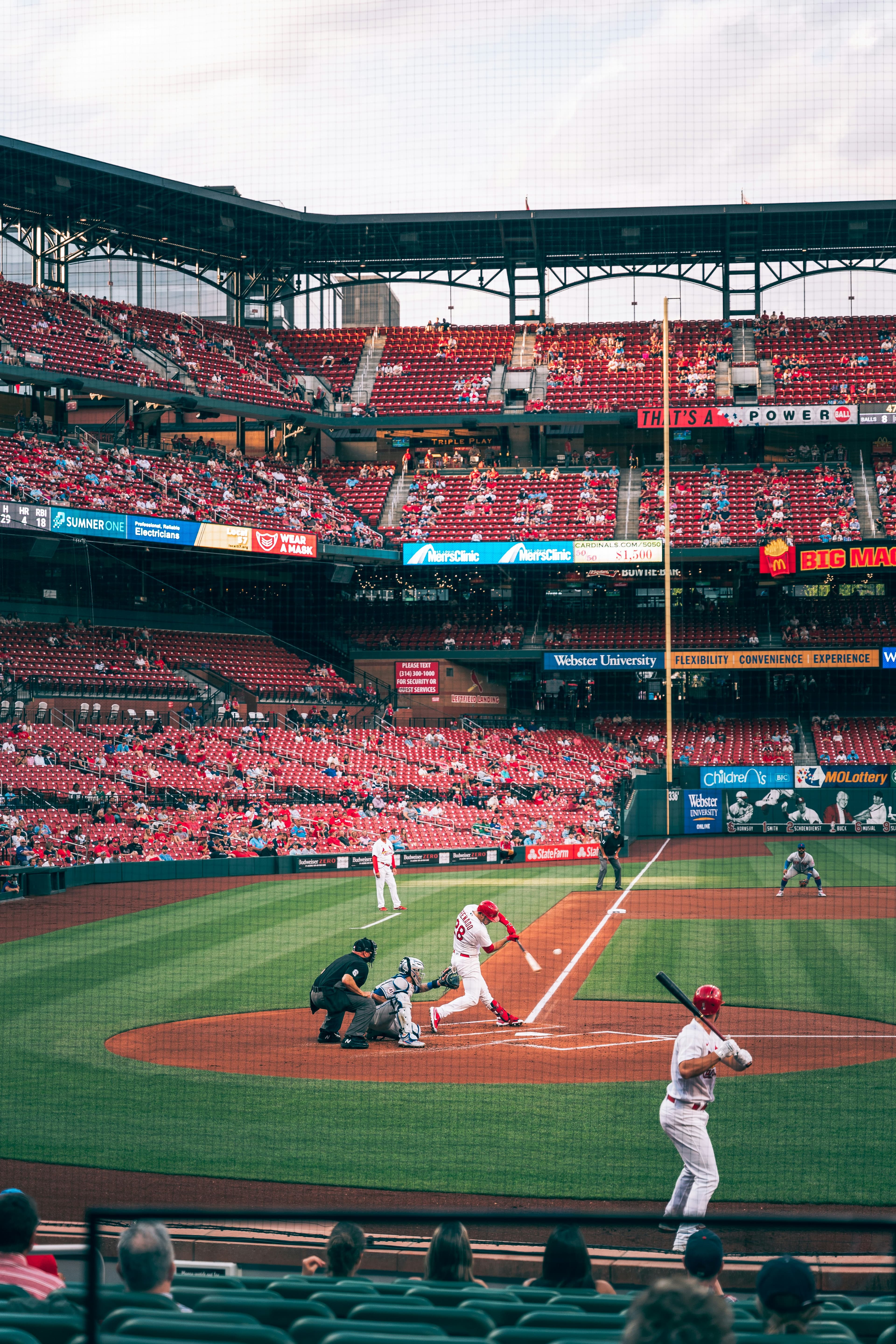 Fans watching a baseball game during the day. Photo by Kirk Thornton on Unsplash